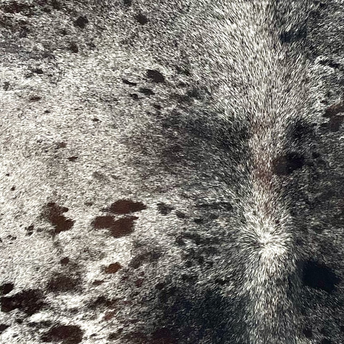 Closeup of this Dark Tricolor Speckled Brazilian Cowhide, showing white with black speckles, and dark brown and black spots (BRSP3536)