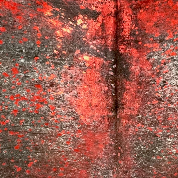 Closeup of this Speckled Colombian Cowhide, showing brown with white speckles, and a red, metallic acid wash  (COAW513)