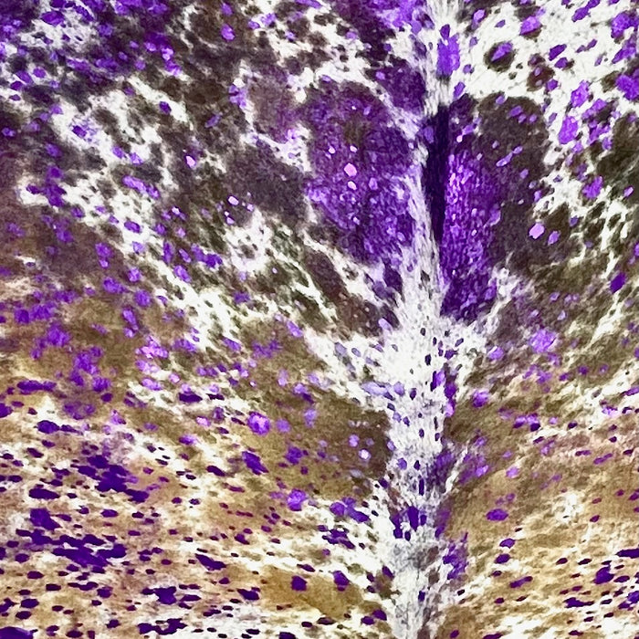 Closeup of this Large Tricolor Speckled Colombian Cowhide, showing white with black and brown speckles and spots, and a metallic, purple acid wash (COAW516)