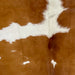 Closeup of this Brazilian Cowhide, showing brown with small and large, white spots (BRBNW366)