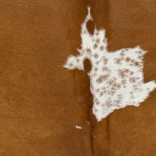 Closeup of this Brazilian Cowhide, showing  brown with one white spot in the middle that has cloudy speckles (BRBNW394)