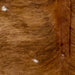 Closeup of this Large Brazilian Brindle Cowhide, showing brown and reddish brown with black, brindle markings, and a few small, white spots  (BRBR1220)