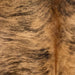 closeup of this Brazilian Brindle Cowhide, showing  light brown with black, brindle markings, and reddish brown down the spine (BRBR1362)