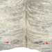 Closeup of this Large Brazilian  Ivory, Cream, Gray Lt Brindle Cowhide, showing one brand mark on each side of the butt  (BRBR1472)