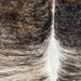 closeup of this XXL Brazilian Brindle Cowhide, showing light tan and brown, with black, brindle markings, and white down the spine (BRBR1530)