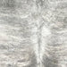 Closeup of this Brazilian Brindle Cowhide, showing white with gray, brindle markings, and two light brown spots (BRBR1538)