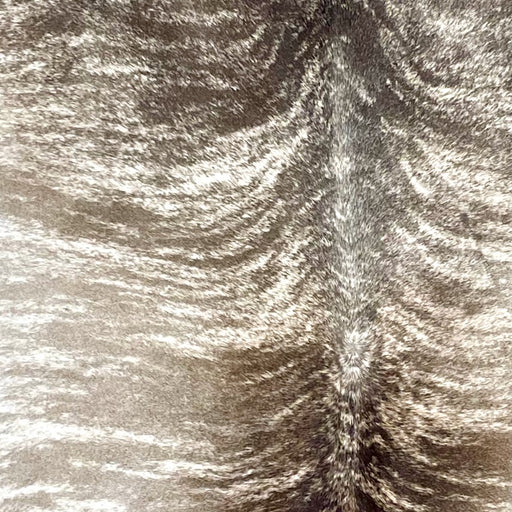 Closeup of this Brazilian Brindle Cowhide, showing white with brown and taupe, brindle markings (BRBR1548)