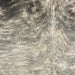 Closeup of this XL Brazilian Cowhide, showing ivory with gray and black, brindle markings (BRBR1701)