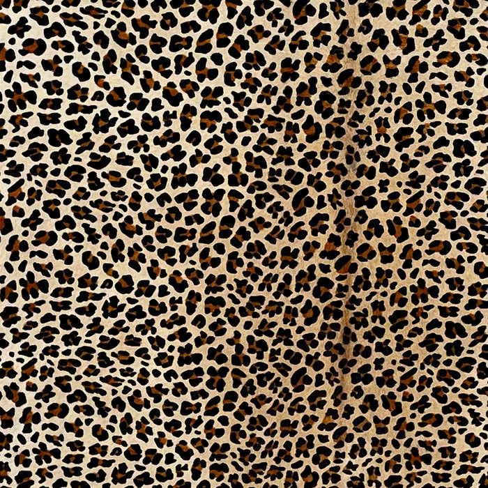 Closeup of this Large, Light Beige Brazilian Cowhide, showing light brown down the middle, and a brown and black, leopard print (BRLP109)