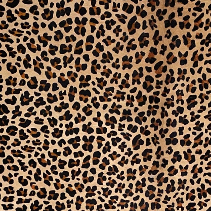 Closeup of this Light Brown Brazilian Cowhide, showing a stenciled, brown and black, leopard print (BRLP125)