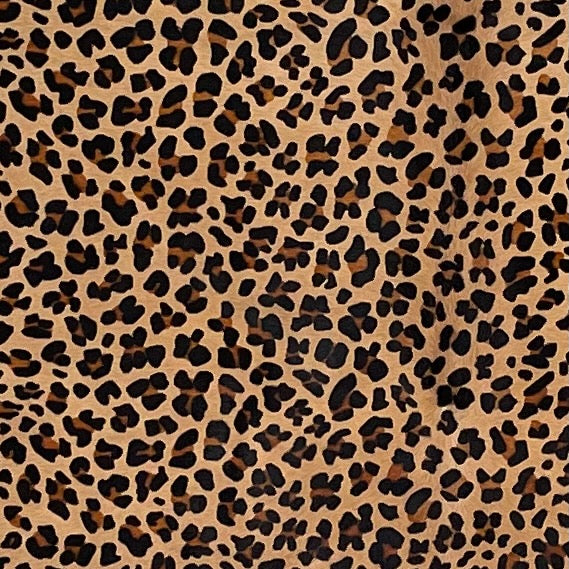 closeup of this Light Brown Brazilian Cowhide, showing a stenciled, brown and black, leopard print (BRLP126)