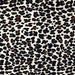 Closeup of this Brazilian Cowhide, showing off-white with a black and brown, stenciled, leopard print (BRLP150)