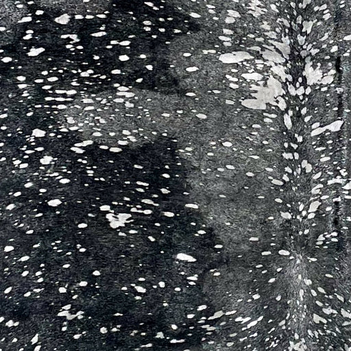 Closeup of this Dyed Black Brazilian Cowhide, showing a metallic, Silver Acid Wash (BRSLDAW509)