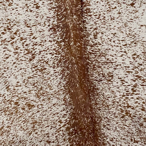 Closeup of this Large, Off-White, Brazilian Cowhide, showing a Brown, Speckled Print (BRSP-P002)
