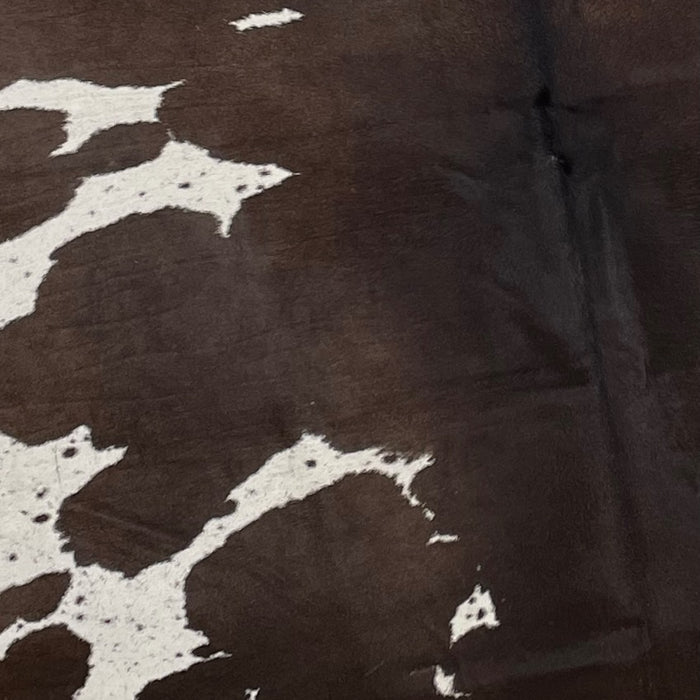 Closeup of this Large, Dark Brown and White, Speckled, Brazilian Cowhide, showing dark brown with a few white spots that have dark brown speckles (BRSP1881)