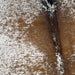 Closeup of this Large, White and Brown, Speckled, Brazilian Cowhide, showing white with brown speckles and spots, and a few black speckles on the spine (BRSP1916)