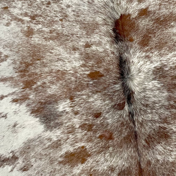 Closeup of this Speckled Brazilian Cowhide, showing off-white, with brown speckles and spots (BRSP2278)