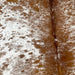 Closeup of this Large, Speckled, Brazilian Cowhide, showing white with brown speckles and spots on the side, and brown, with white speckles, down the middle (BRSP2290)