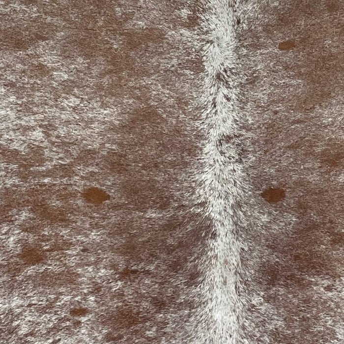 Closeup of this Speckled, Brazilian Cowhide, showing off-white with brown speckles and a few brown spots (BRSP2536)