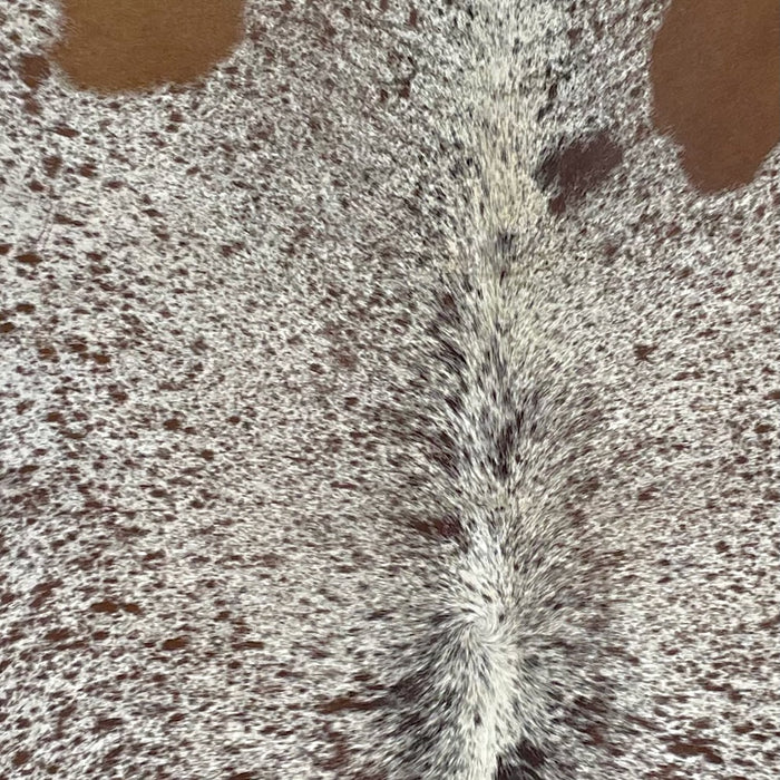 Closeup of this Speckled Brazilian Cowhide, showing off-white with brown speckles and spots (BRSP2543)