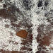 Closeup of this Tricolor, Speckled, Brazilian Cowhide, showing white with brown speckles and spots on the back, and black speckles and spots on the shoulder (BRSP2611)