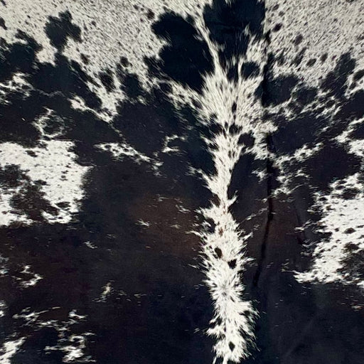 Closeup of this Large, Speckled, Brazilian Cowhide, showing white with black speckles and large and small, black spots, with hints of dark brown in the middle (BRSP2631)