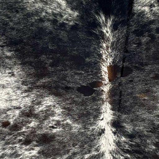 closeup of this Speckled Brazilian Cowhide, showing white with black speckles and spots, and some small, dark brown spots in the middle (BRSP2640)