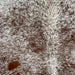 Closeup of this Speckled Brazilian Cowhide, showing white with reddish brown speckles and spots (BRSP2710)