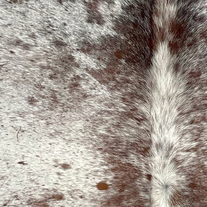 Closeup of this Speckled Brazilian Cowhide, showing off-white with brown speckles and spots  (BRSP2761)