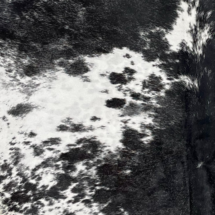 Closeup of this XXL Speckled Brazilian Cowhide, showing black with white speckles and spots on the shoulder and down the middle, and white with black speckles and spots on the sides (BRSP2927)