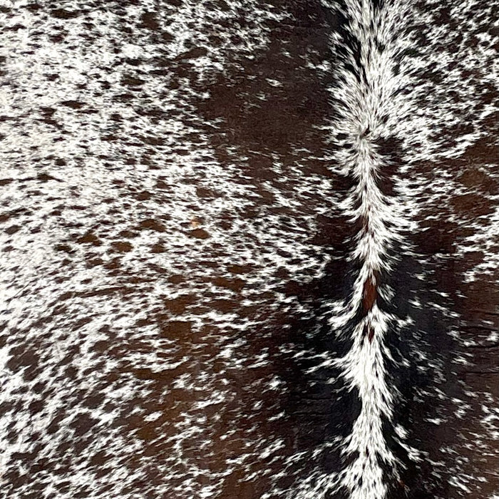 Closeup of this Tricolor Speckled Brazilian Cowhide, showing white with brown and black spots and speckles (BRSP2941)