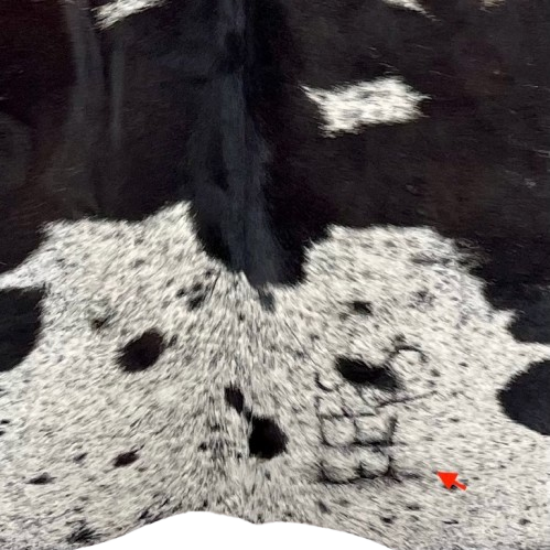 Closeup of this Large Dark Brown and White Speckled Brazilian Cowhide, showing one brand mark on the right side of the butt (BRSP2967)