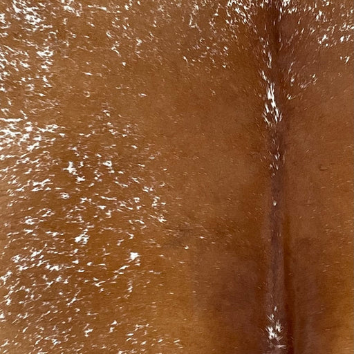 Closeup of this Speckled Brazilian Cowhide, showing reddish brown with white speckles down the middle  (BRSP2968)