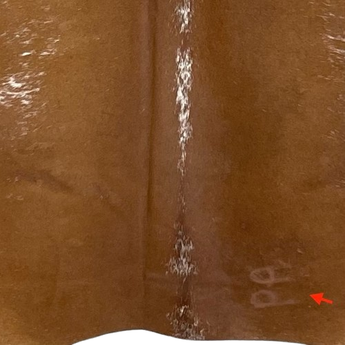 Closeup of this brown and white Speckled Brazilian Cowhide, showing one brand mark on the right side of the butt  (BRSP3025)