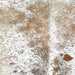 Closeup of this Speckled Brazilian Cowhide, showing off-white and almond with brown speckles and spots (BRSP3125)
