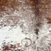 Closeup of this Speckled Brazilian Cowhide, showing white with reddish brown speckles and spots, and one brand mark on the left side of the back (BRSP3139)
