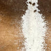 Closeup of this Tricolor Speckled Brazilian Cowhide, showing caramel and brown, with white speckles, down both sides, and white, with caramel and chocolate speckles, down the middle  (BRSP3177)