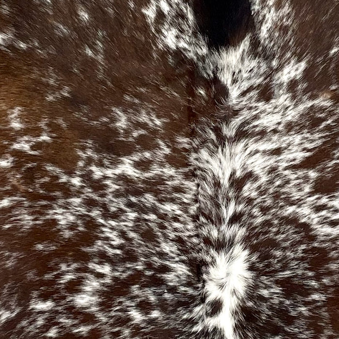 Closeup of this Speckled Brazilian Cowhide, showing white with brown speckles and spots, and it is off-white (BRSP3178)