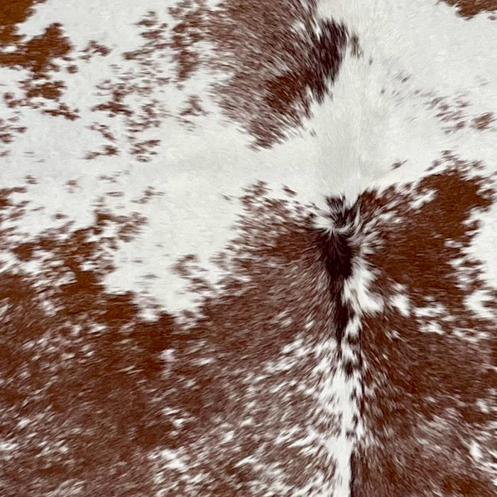Closeup of this Speckled Brazilian Cowhide, showing white with reddish brown speckles and spots (BRSP3243)
