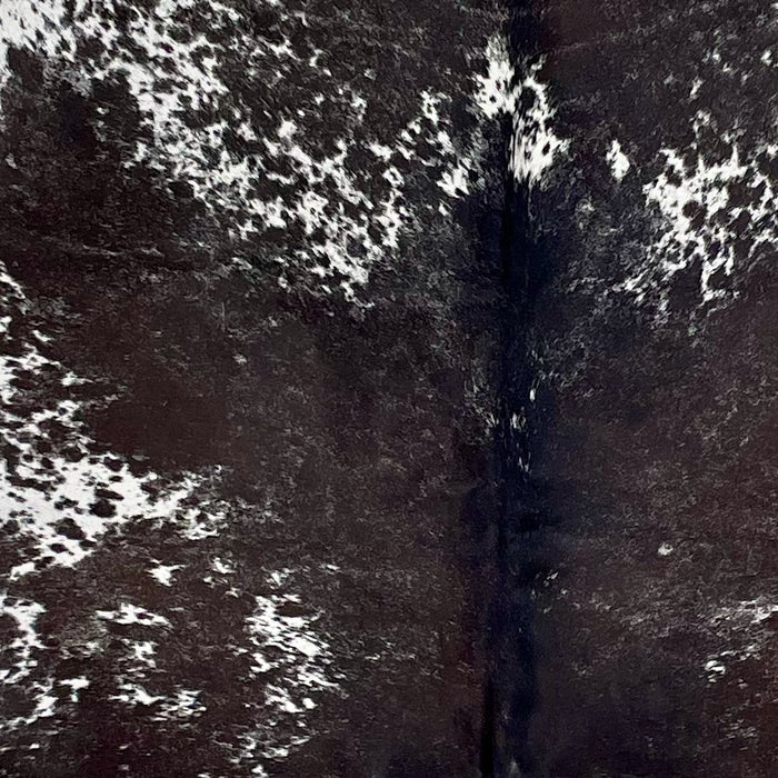 Closeup of this Large Blackish Speckled Brazilian Cowhide, showing white with blackish brown speckles and spots, and mostly solid blackish brown down the middle  (BRSP3309)