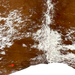 Closeup of this reddish brown and white Speckled Brazilian Cowhide, showing one brand mark on the left side of the butt  (BRSP3327)