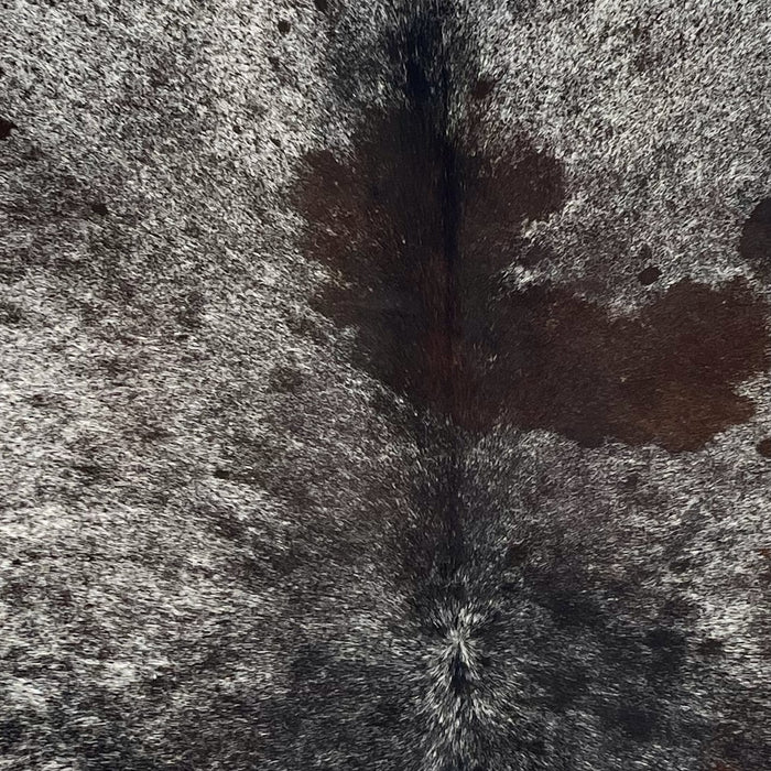 Closeup of this Speckled Brazilian Cowhide, showing black and white speckled with a dark brown spot in the middle of the shoulder (BRSP3702)