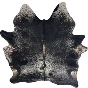 Black and White Speckled Brazilian Cowhide: black with white speckles and spots, brown down the spine, and one brand mark on the left side of the back - 6'11" x 5'7" (BRSP3717)