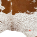 Closeup of this reddish brown and white Cloudy Speckled Brazilian Cowhide, showing one brand mark on the left side of the butt (BRSP3805)