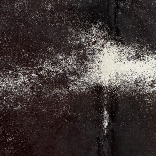 Closeup of this Dark Tricolor Speckled Brazilian Cowhide, showing a mix of black and dark brown, white spots with black speckles (BRSP3837)