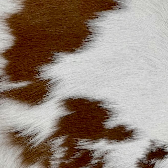 Closeup of this White and Chocolate Calfskin, showing white with chocolate spots (CALF598)