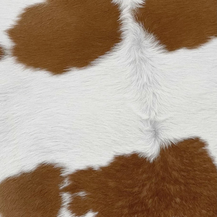 Closeup of this White and Brown Calfskin, showing white with a few brown spots on the shoulder, and in the middle of the back (CALF606)