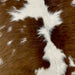 Closeup of this Brown and White Calfskin, showing white with large and small brown spots (CALF667)