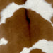 Closeup of this Brown and White Calfskin, showing brown with three large, white spots across the middle (CALF670)