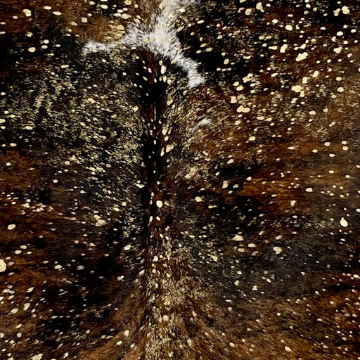 Closeup of this Colombian Cowhide, showing tricolor with a metallic, gold acid wash  (COAW432)